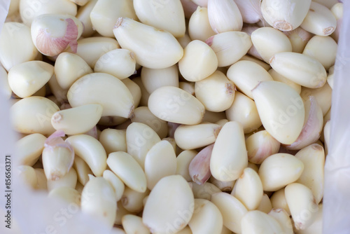 peeled garlic in stainless steel basin