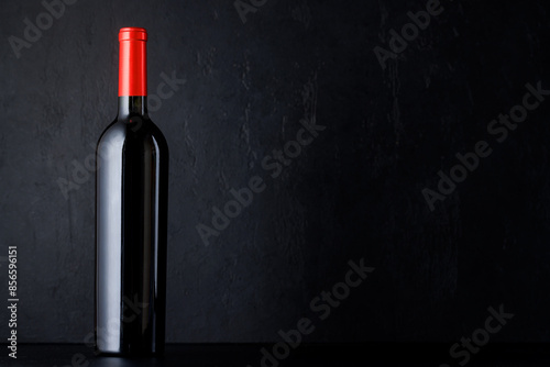 Red wine bottle over black
