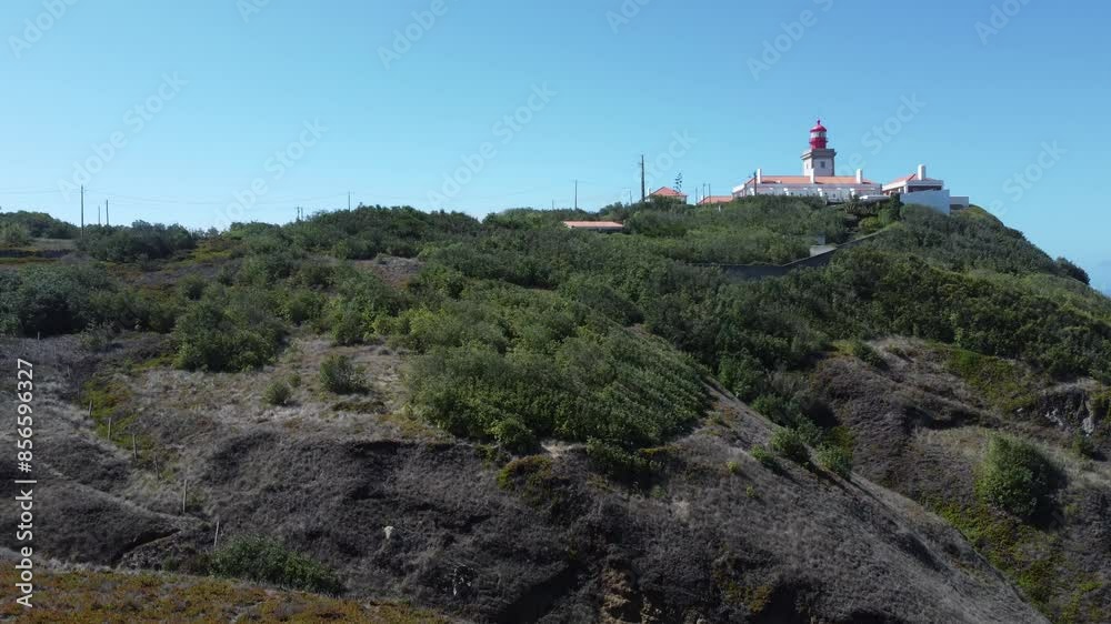 Immerse yourself in the daytime beauty of the Portuguese landscape as the drone unveils hidden coves and dramatic cliffs surrounding the lighthouse. Immerse yourself in the daytime beauty of the Portuguese landscape as the drone unveils hidden coves and dramatic cliffs surrounding the lighthouse.