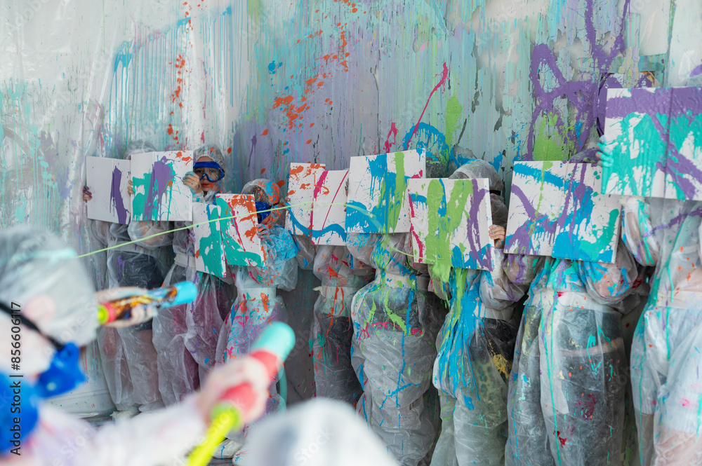 Fototapeta premium Shooting with liquid acrylic paints in the room. Child's play