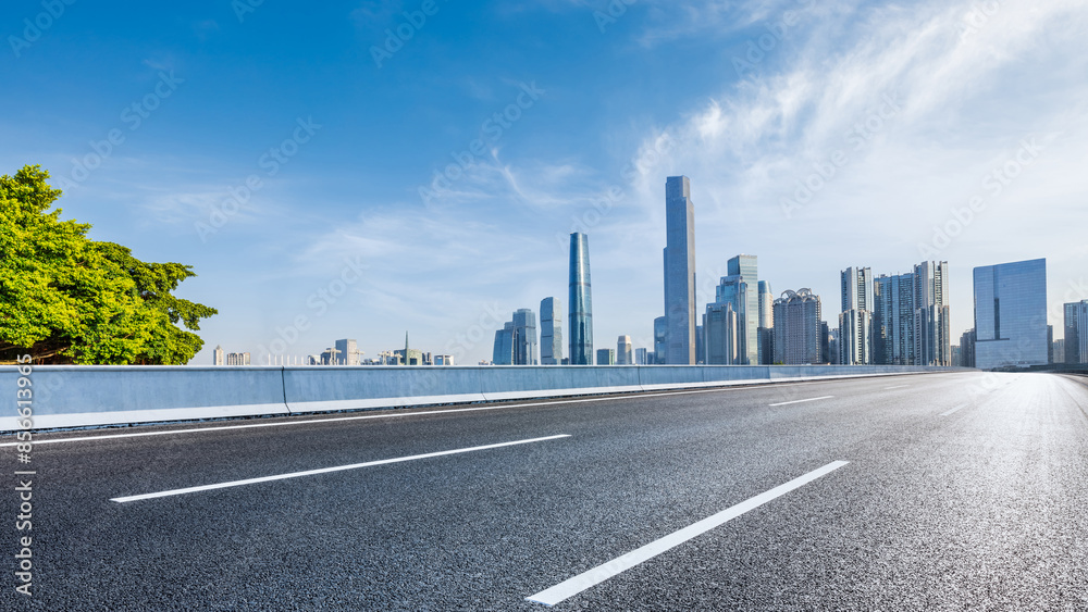 Asphalt highway road and city skyline with modern buildings scenery in Guangzhou. Car background. Asphalt highway road and city skyline with modern buildings scenery in Guangzhou. Car background.