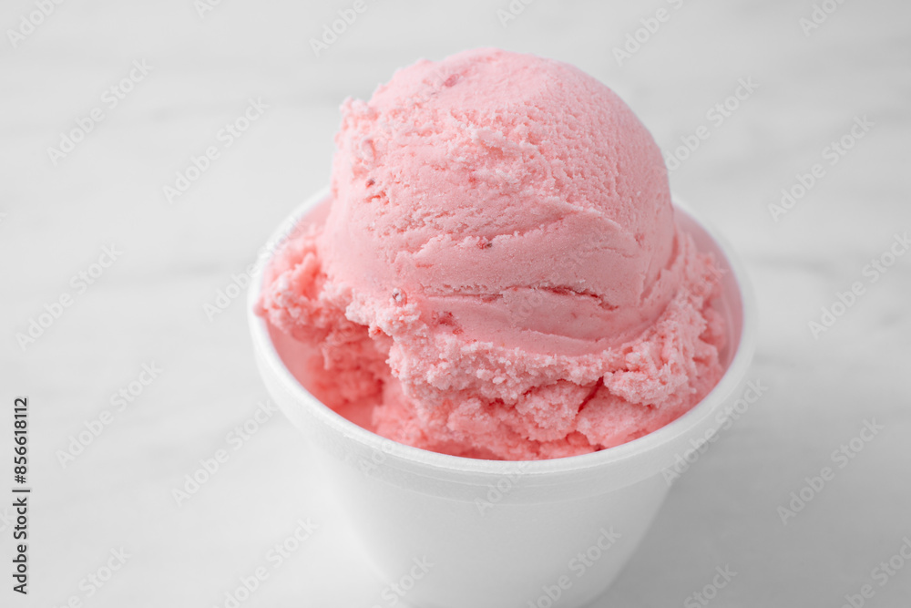 A closeup view of a scoop of strawberry ice cream. A closeup view of a scoop of strawberry ice cream.