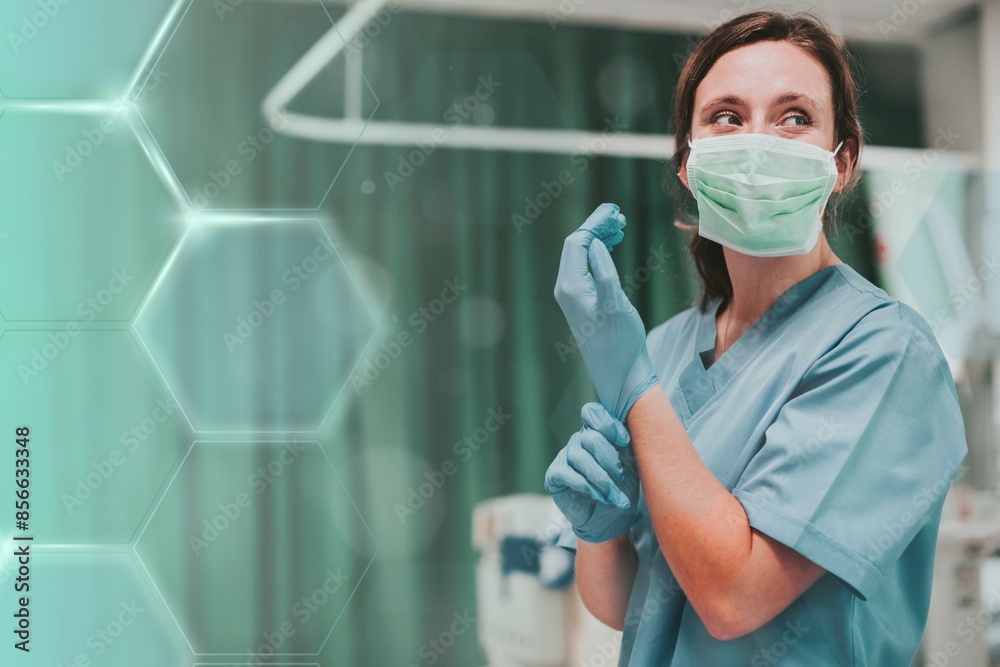 Fototapeta premium Female nurse with a mask putting on gloves