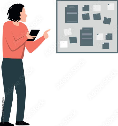 A boy is looking at notices on a notice board.