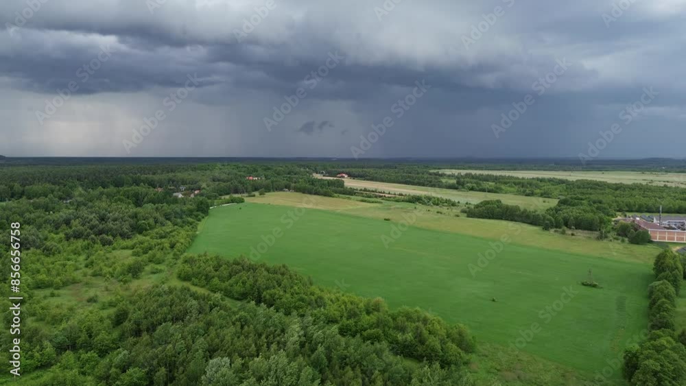 storm clouds over green fields and forest storm clouds over green fields and forest