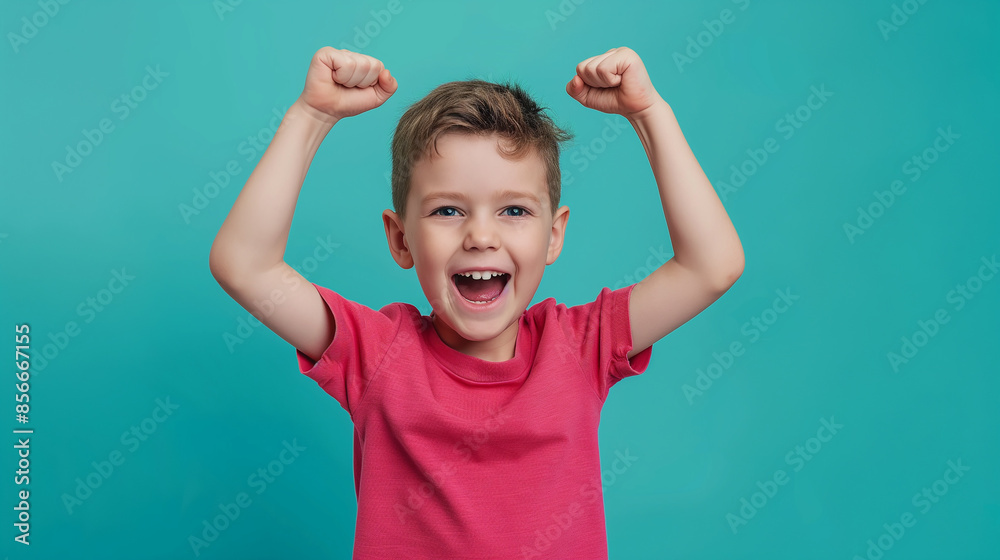 Winner kid isolated over turquoise background, show how powerful he is Winner kid isolated over turquoise background, show how powerful he is