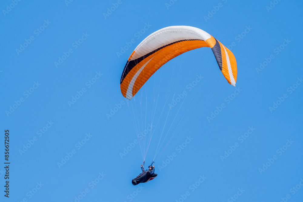 Serramazzoni, Italy - 06 19 2024: Paraglider flies in the air. Aerial view of paragliding. Paraglider flies in a bright sunny day. Concept of extreme sport.
Serramazzoni, Italy - 06 19 2024: Paraglider flies in the air. Aerial view of paragliding. Paraglider flies in a bright sunny day. Concept of extreme sport.