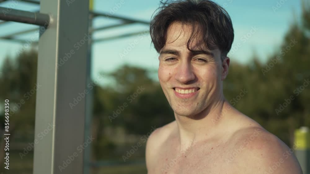 Fit young adult male pauses to rest during sunset, displaying calmness and determination