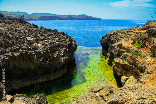 rocky coast of the sea, angel billabong beach, nusa penida island, bali, indonesia photo