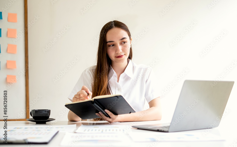 Asian businesswoman sit at their desks and calculate financial graphs showing results about their investments and plan successful business growth process Asian businesswoman sit at their desks and calculate financial graphs showing results about their investments and plan successful business growth process