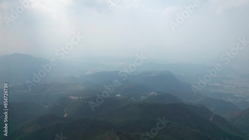 Drone view of green forest on mountain, high angel view of mountain valley in sunny day, 4k real time footage flying establishing shot, Xingmeijian mountains in fuyang, Hangzou, China. photo
