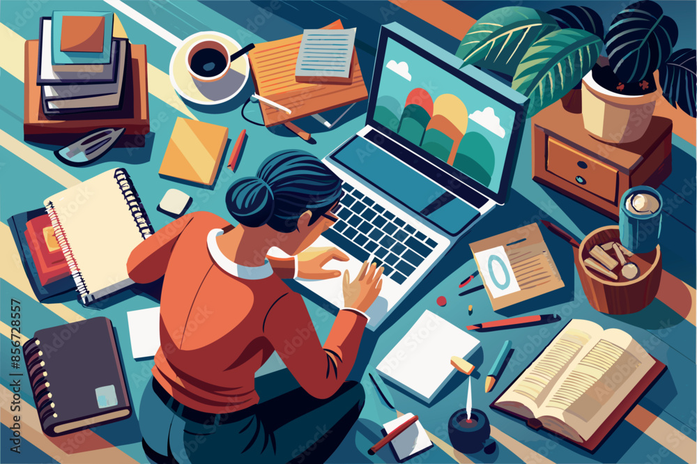 Fototapeta premium top view of a manager sitting at a desk working on a laptop. The desk is cluttered with various items. The atmosphere suggests an informal but busy workspace at home