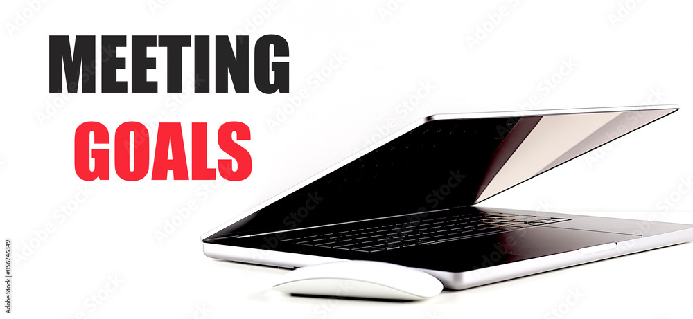MEETING GOALS text on white background with laptop and mouse MEETING GOALS text on white background with laptop and mouse