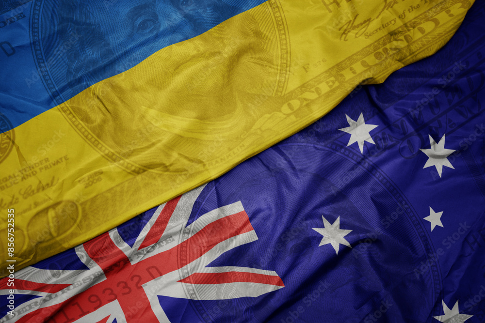 waving colorful flag of ukraine and national flag of australia on the dollar money background. finance concept. waving colorful flag of ukraine and national flag of australia on the dollar money background. finance concept.