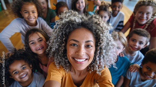 Multicultural classroom, Afroamerican teacher, smiling, surrounded by children, all learning at the same time