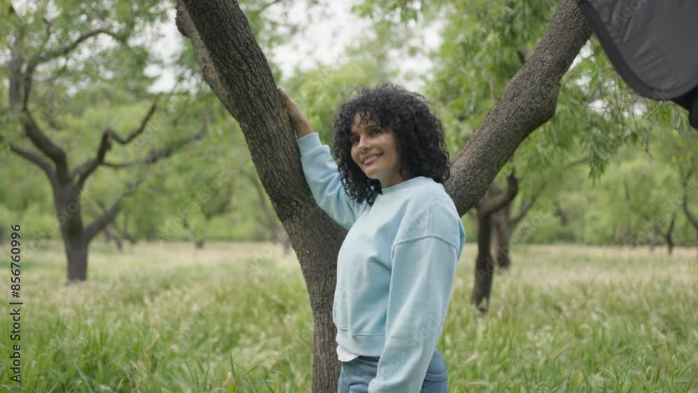 Model with curly hair posing for camera in a field during photoshoot.MOV Model with curly hair posing for camera in a field during photoshoot.MOV