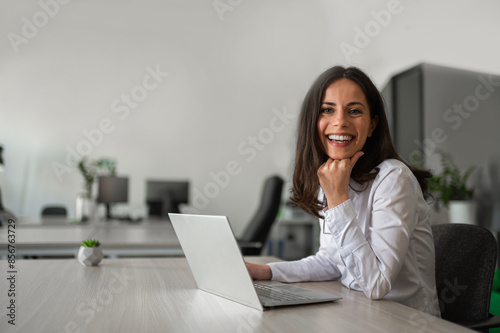 Joyfull young businesswoman in coworking space