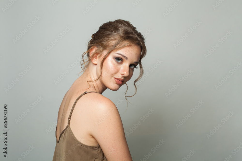 Smiling good-looking woman with updo hairstyle and makeup. Young female model portrait Smiling good-looking woman with updo hairstyle and makeup. Young female model portrait