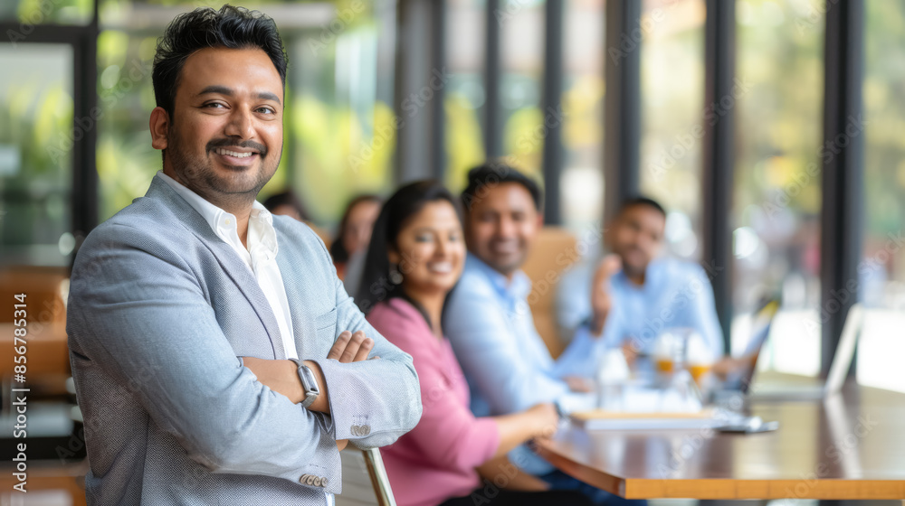 Confident Indian Male Executive Smiling During a Corporate Discussion, Professional Work Environment Confident Indian Male Executive Smiling During a Corporate Discussion, Professional Work Environment