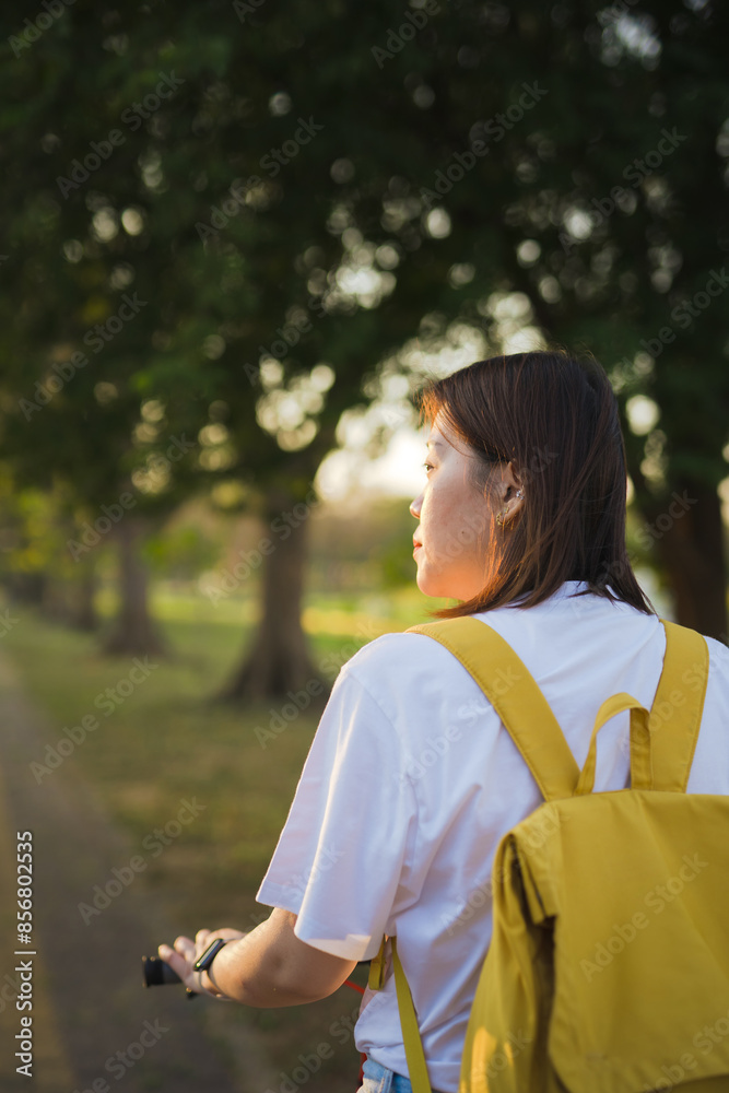 spring is comming concept with happy and cheerful feeling of asian woman riding bicycle