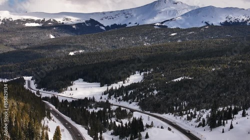 i70 highway Vail Pass Colorado aerial drone cars trucks sky chutes Copper Mountain ski resort trail runs ten mile range Ikon epic winter snowy peaks clouds sunset golden hour pan up forward motion photo