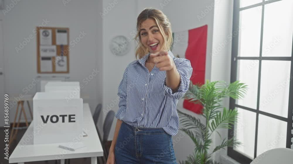 A smiling young woman pointing at the camera in a polling station with a mexican flag. A smiling young woman pointing at the camera in a polling station with a mexican flag.