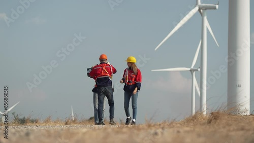Wallpaper Mural Young man and woman maintenance engineer team. two engineer operate wind turbine. Engineer and worker discussing on a wind turbine farm. Wind Turbine. Maintenance Workers. renewable energies. Torontodigital.ca