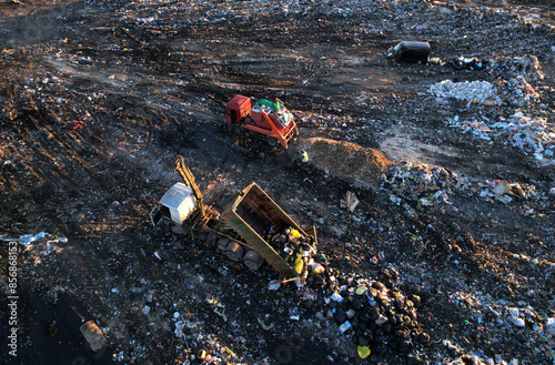 Landfill garbage truck. Garbage truck unloads rubbish in landfill. Landfill waste disposal. Garbage dump, waste plastic. Reduce greenhouse, methane emissions. Mustard gas among toxic waste in landfill