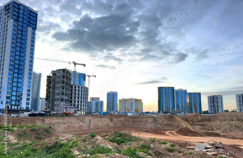 Construction crane on Housing. Construction site with buildings under construction. Tower cranes in action. Crane on formworks. Multi Storey Residential Buildings. Foundation construction. Groundworks