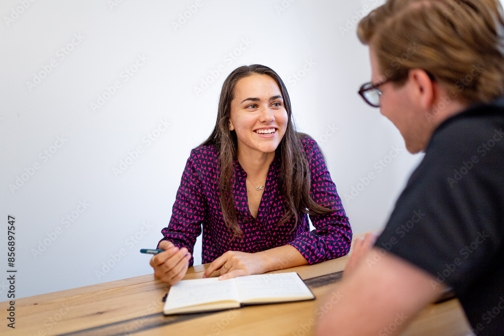 Aboriginal woman talking to a man with glasses in an office Aboriginal woman talking to a man with glasses in an office
