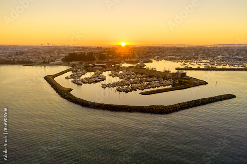 Sunrise on the misty horizon over Fremantle's challenger harbour marina in Western Australia. photo