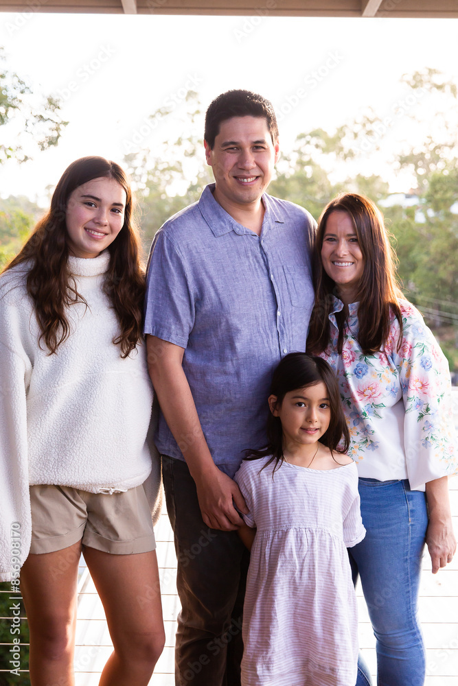 Portrait of a happy family smiling looking at the camera on the house balcony Portrait of a happy family smiling looking at the camera on the house balcony