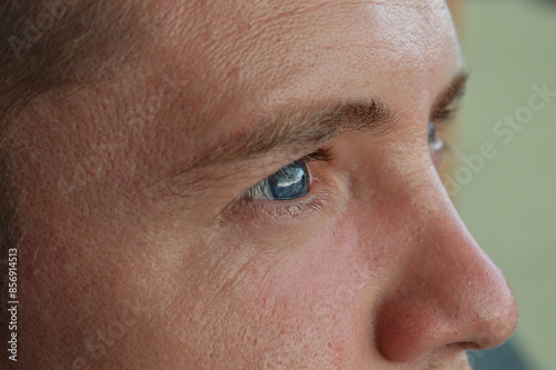 A guy's face and eyes. Fine lines on the face of a young guy 28 years old. Close-up of the face.