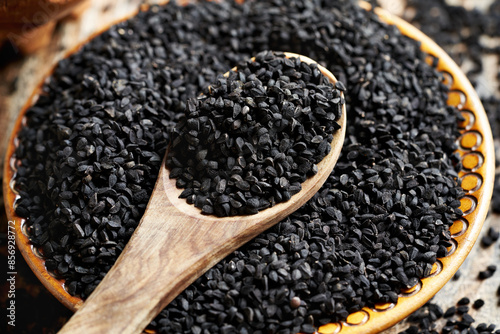 Black cumin or Nigella sativa seeds in a bowl and on a spoon photo