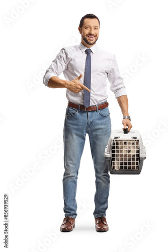 Man holding a pet carrier with a westie dog and pointing photo