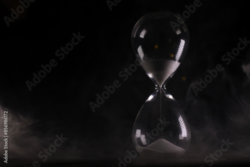 Mystical Hourglass Against a Smoky Backdrop - Timelessness and Mystery in Dark, Artistic Photography