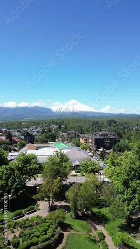 Aerial video over the town of Pocon in the background of the active volcano Villarrica, Chile photo