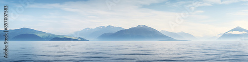 A beautiful blue ocean with mountains in the background