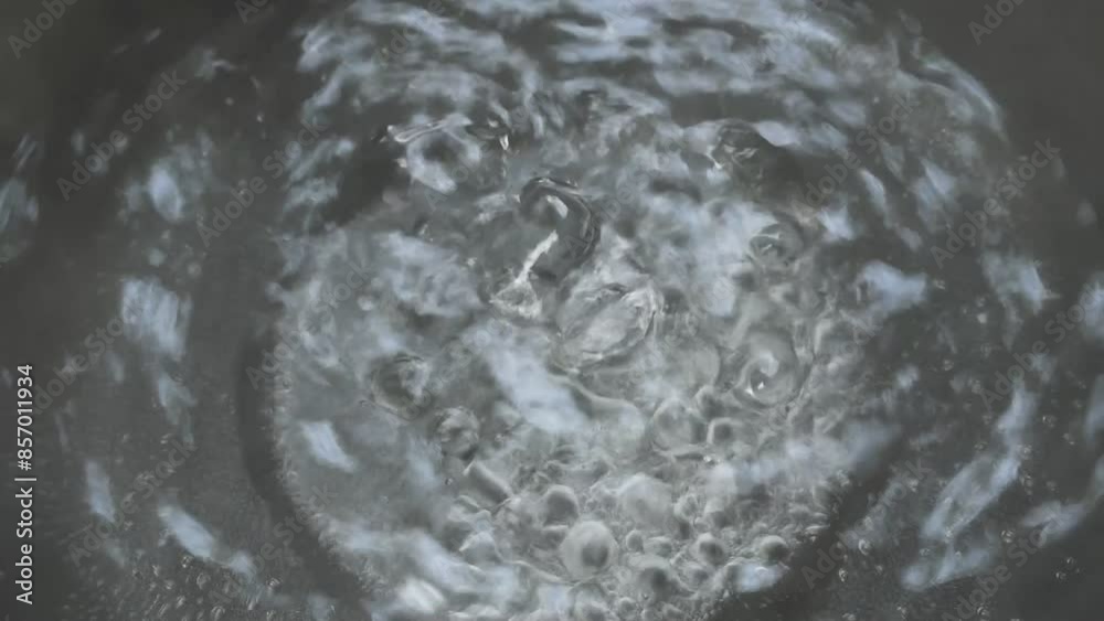 steamed water with bubble boiled in black electric kitchen pan steamed water with bubble boiled in black electric kitchen pan