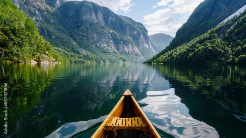 Visualize a serene mountain lake surrounded by lush greenery. Imagine a canoe gliding smoothly across the calm water, with the reflection of the towering peaks mirrored on the surface.
