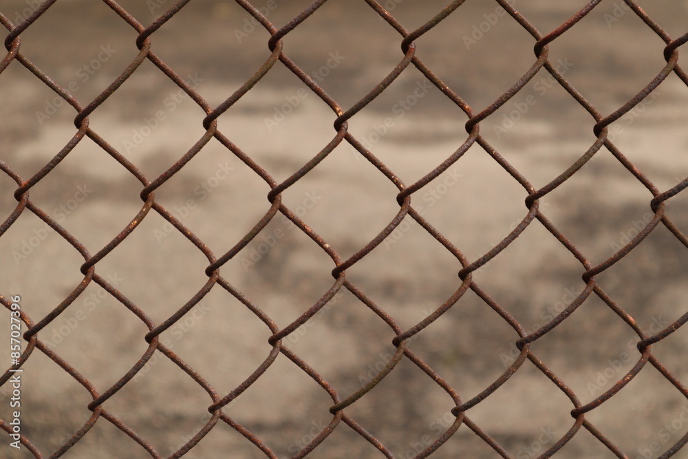 Rusty chain the fence. The texture of the fence can symbolize decay or boundaries. Rusty chain the fence. The texture of the fence can symbolize decay or boundaries.