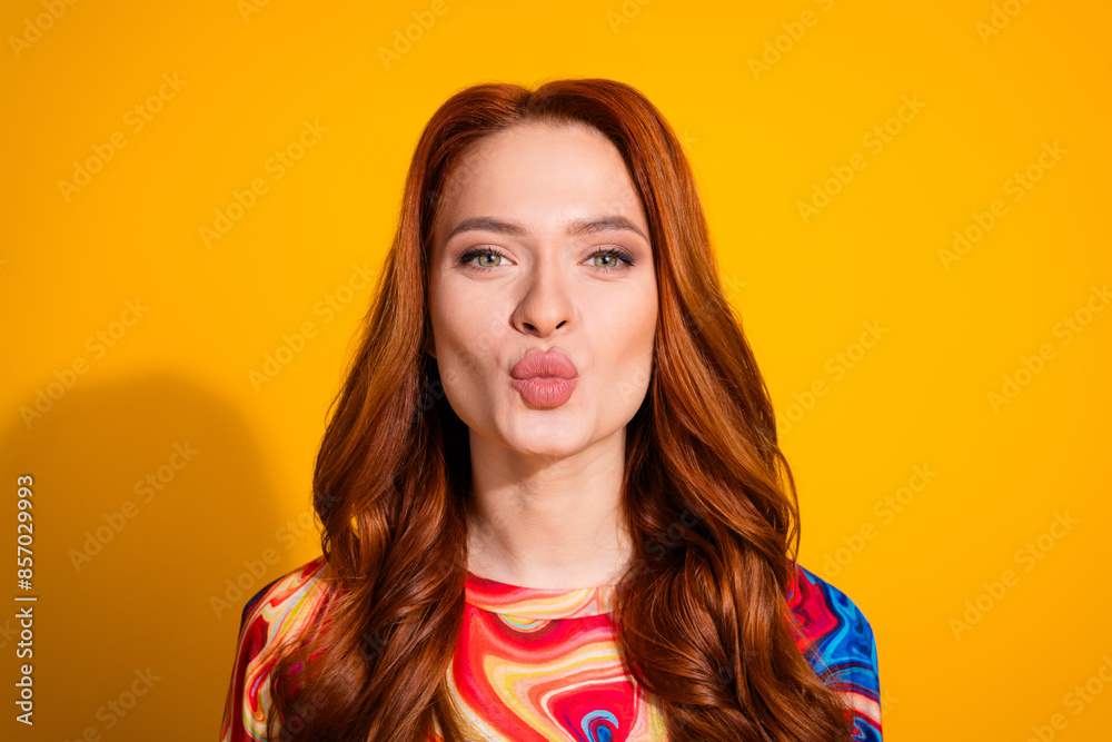 Photo portrait of pretty young girl kissing pouted lips wear trendy colorful outfit isolated on orange color background Photo portrait of pretty young girl kissing pouted lips wear trendy colorful outfit isolated on orange color background