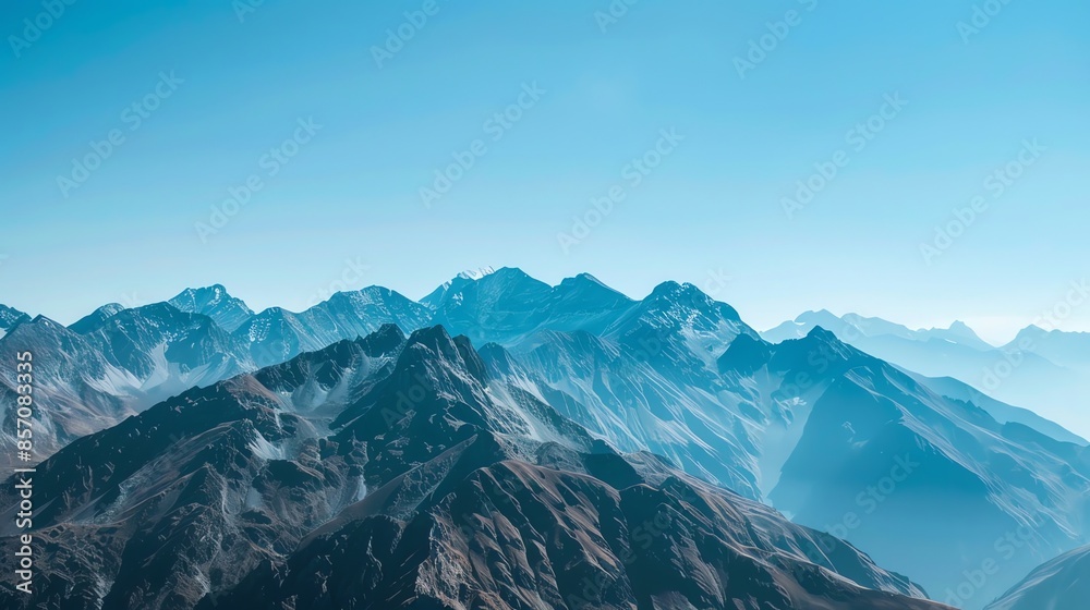 A mountain range with a bright blue sky. A mountain range with a bright blue sky.