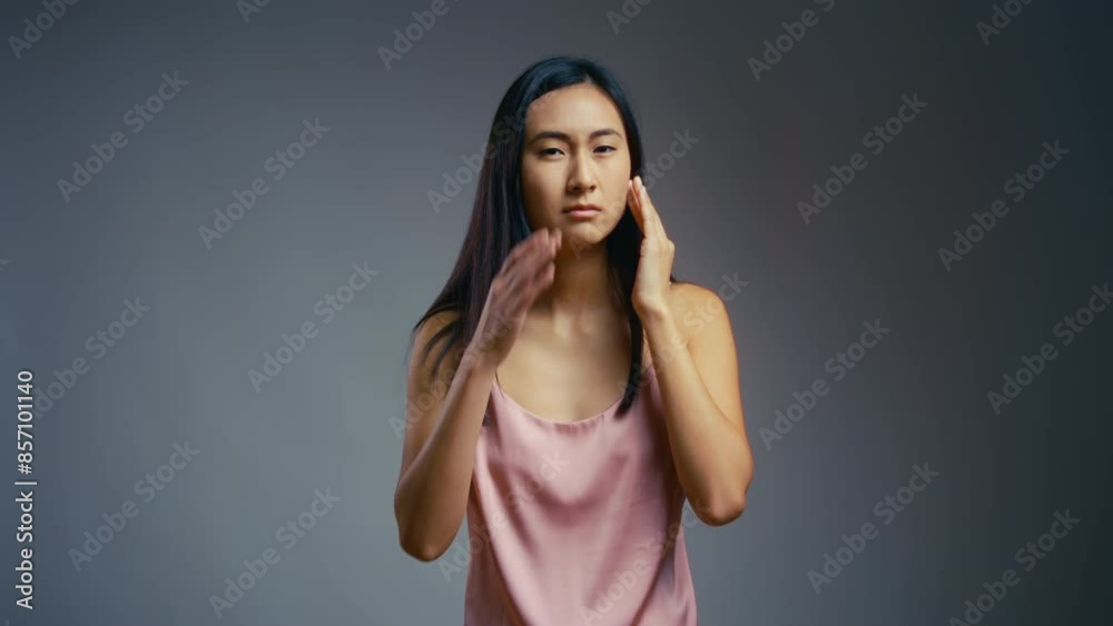 Young Korean woman upset with her face skincare routine, first signs of ageing Young Korean woman upset with her face skincare routine, first signs of ageing