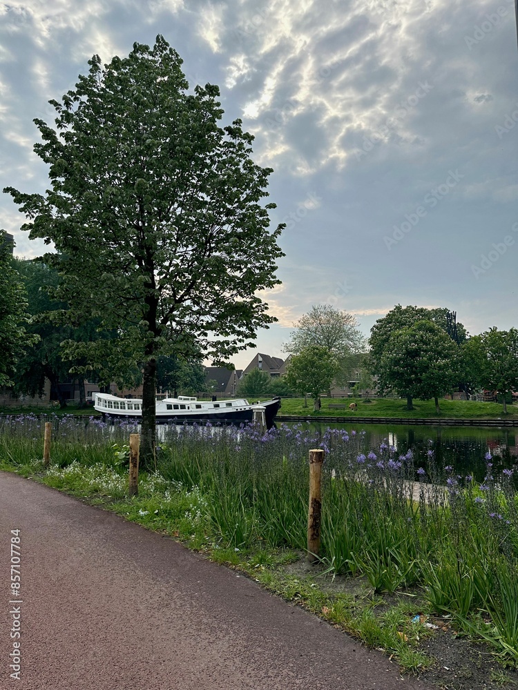 Beautiful view of canal with moored boat in city Beautiful view of canal with moored boat in city