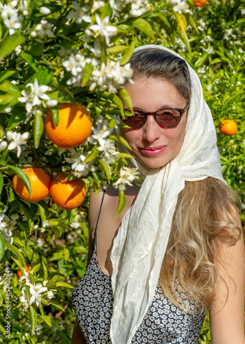 Beautiful woman in orange orchard