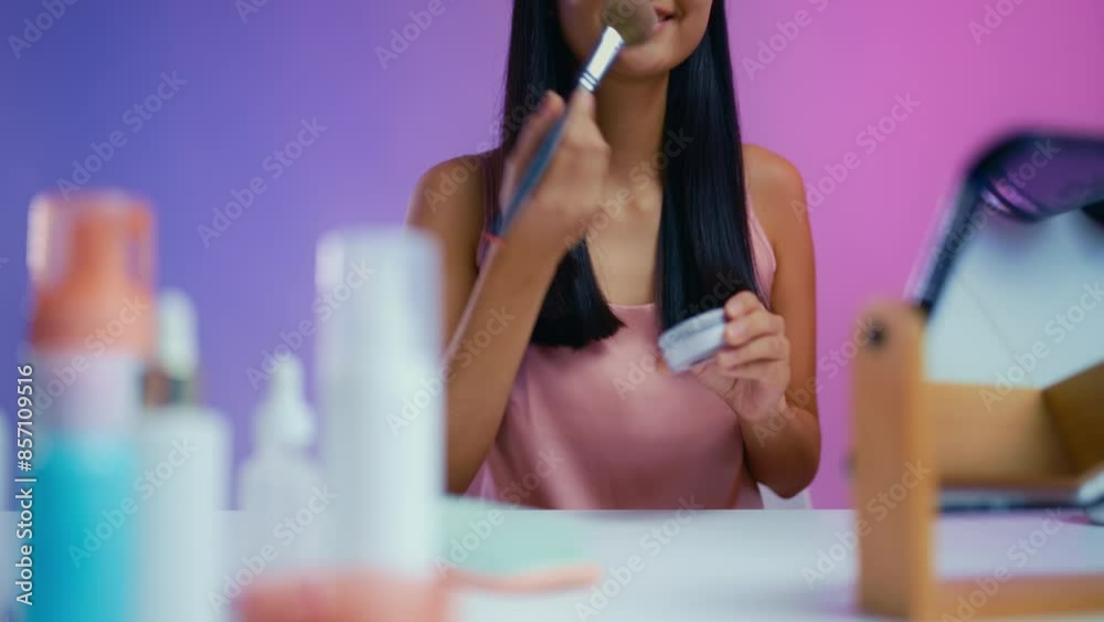 Happy woman applying face powder in front of mirror, beauty routine, make-up Happy woman applying face powder in front of mirror, beauty routine, make-up