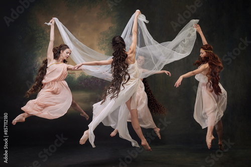 Obraz na plátne Group of young beautiful ballerinas gracefully moves in dance, as muses against vintage studio background