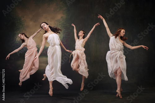 Foto Beautiful girls, ballerinas leaping gracefully in motion, as mythological muses against vintage studio background