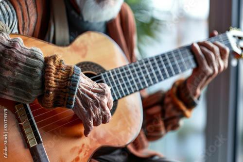 Close-up of elderly hands skillfully playing a classical guitar, capturing the grace and dedication of a seasoned musician. photo